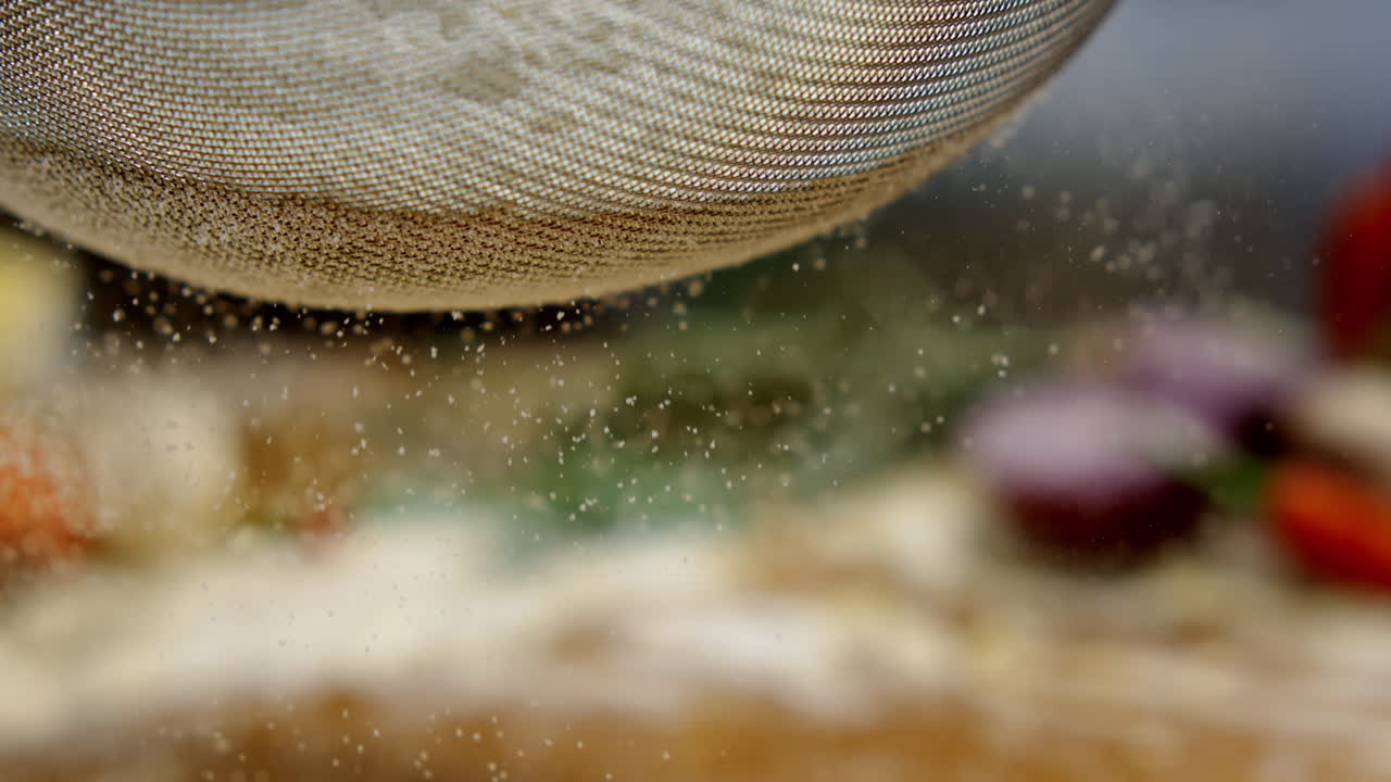 Sifting flour with a sieve for baking