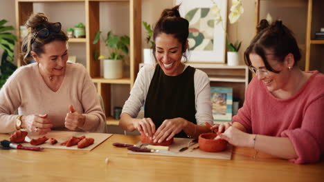 women having fun in a pottery class