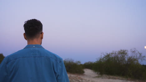 man walking at dusk