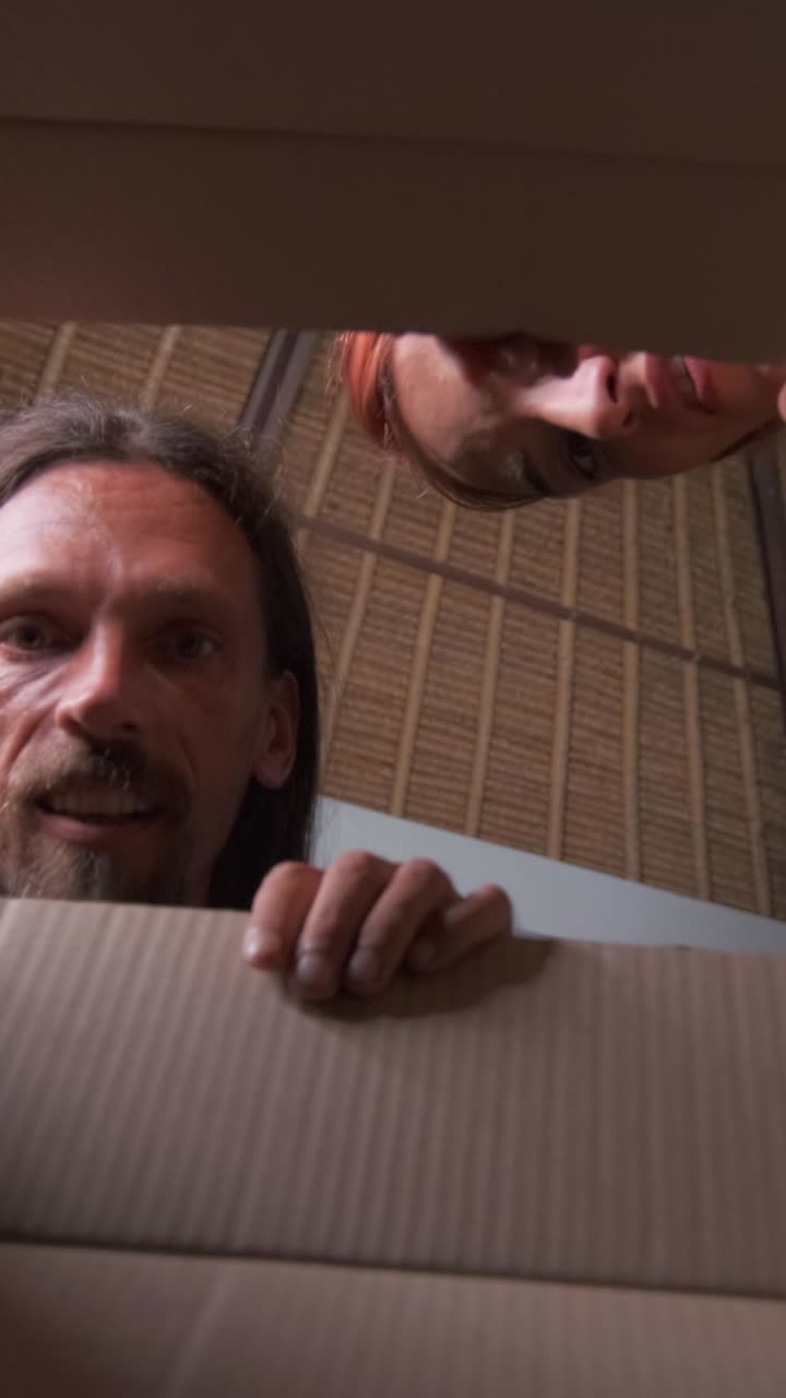 Young happy friendly couple from caucasian man and woman are unboxing parcels