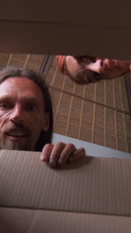 young happy friendly couple from caucasian man and woman are unboxing parcels