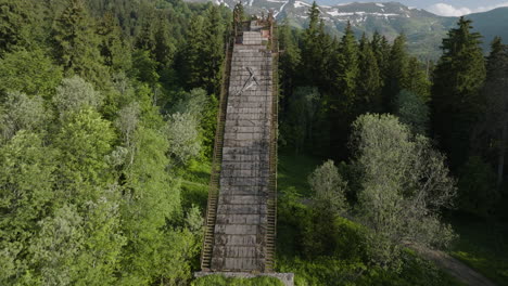 unused ski jump slope within the verdant coniferous forest in georgia