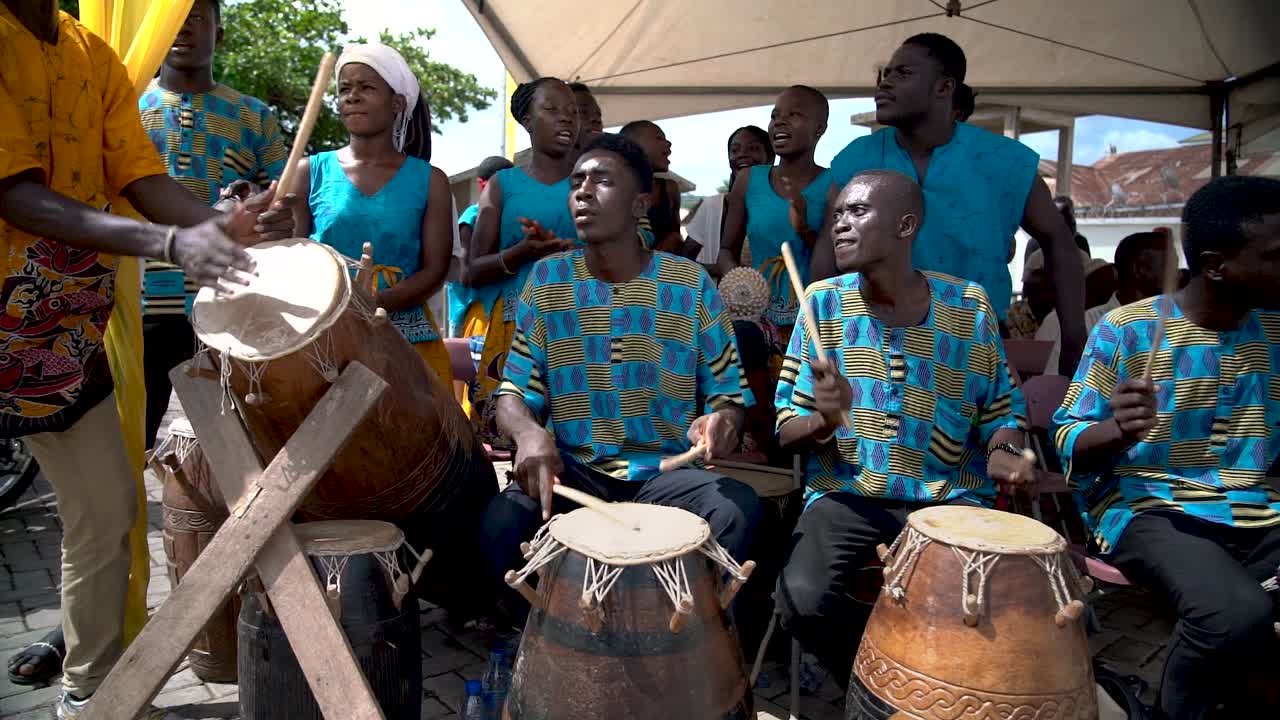 A music group of drummers and singers perform for the annual Yam Festival in Ho, Ghana, West Africa as captured in slow motion at 120fps.