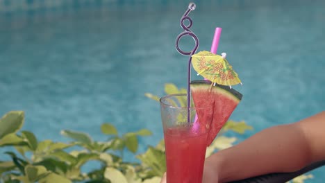 swimming-pool-water-ripples-in-light-wind-behind-cocktail