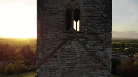 aerial upwards rising shot of burrow mump church tower to reveal a beautiful sunset