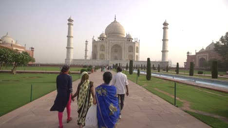 people walking towards the taj mahal