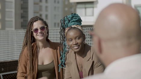 front view of happy women joking with his colleague outdoor