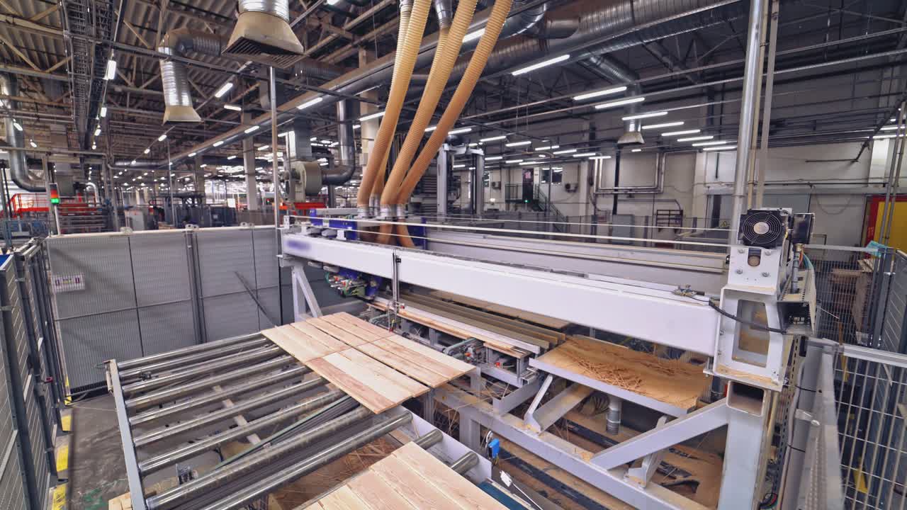 Fast automatic machine levels a surface of wooden boards for their further operation in life. Woodworking factory. Close-up.
