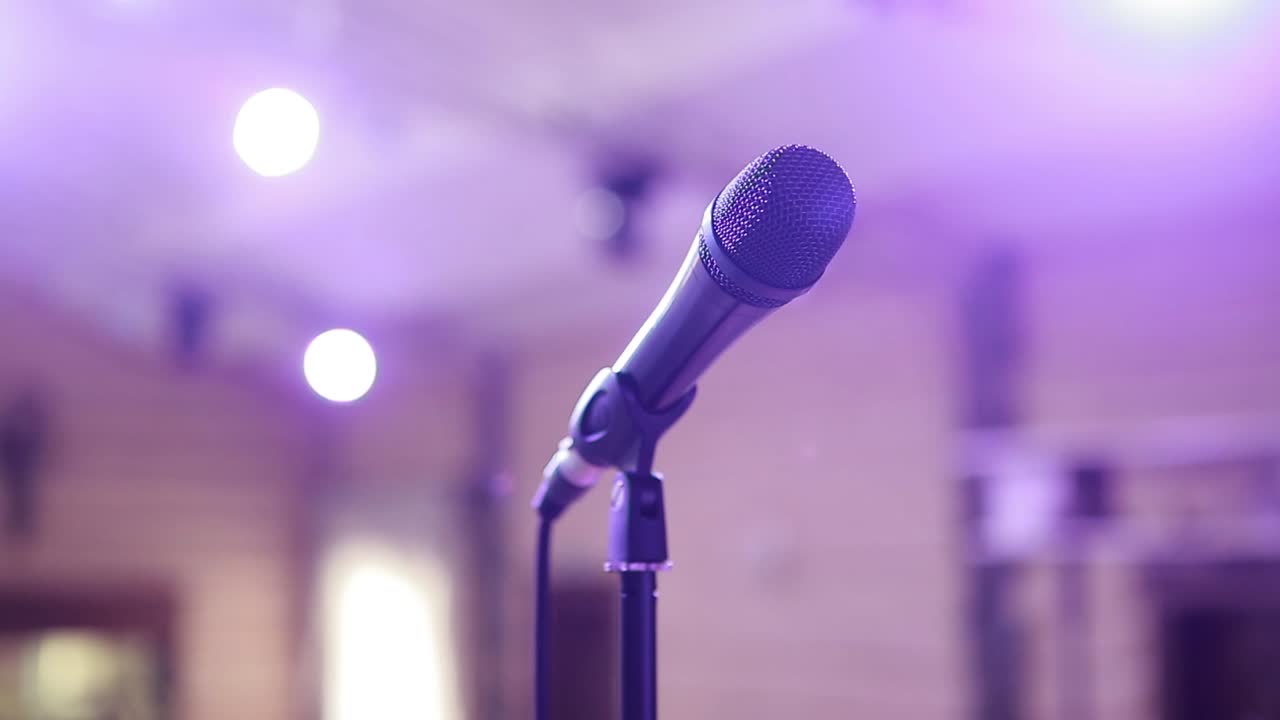 Microphone On Concert Stage. Microphone on stage against a background of auditorium