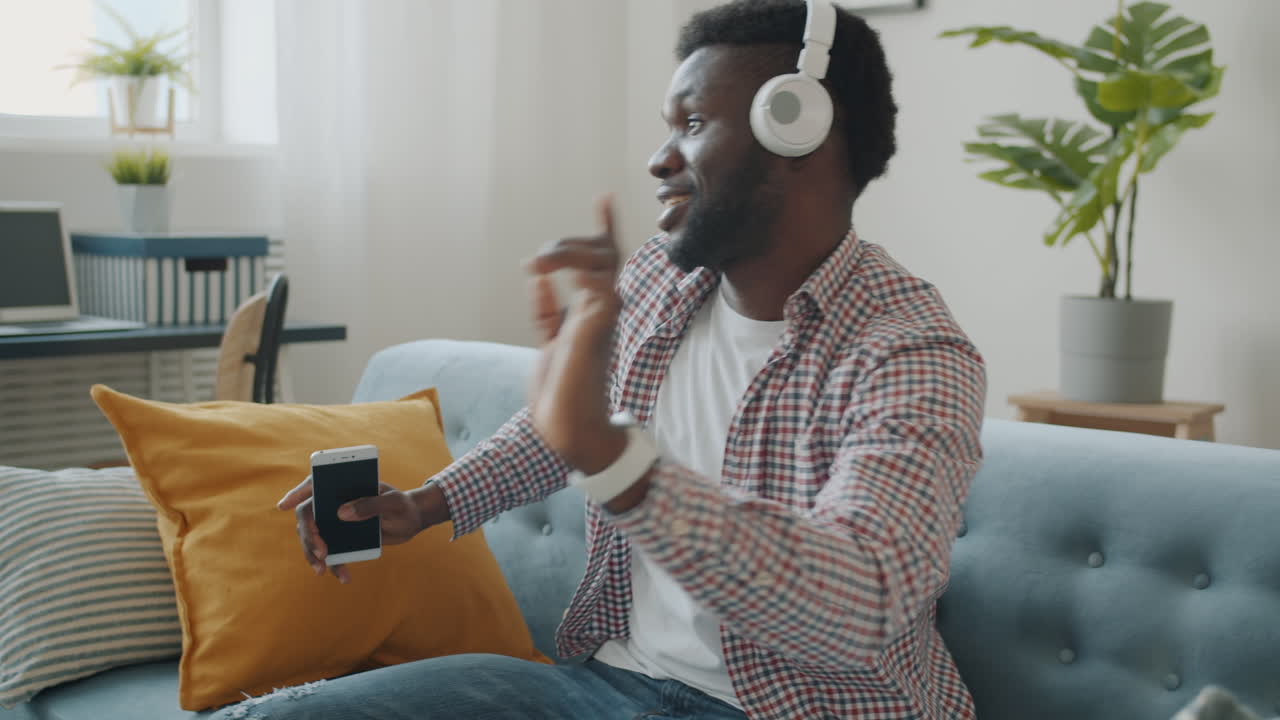 Man Dancing to Music on Couch