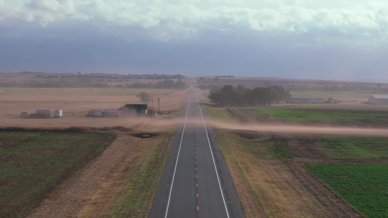Dusty highway stretches through rural Oklahoma, serene and deserted