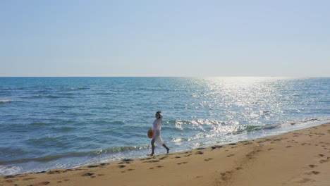 person walking on a beach by the ocean