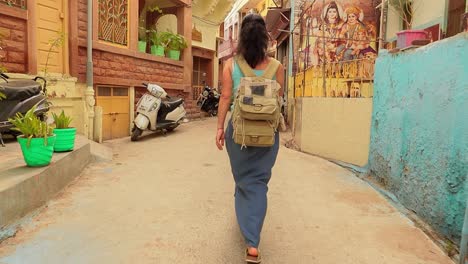 Female-tourist-walks-through-the-streets-of-an-Indian-city.-Rajasthan,-Indian-Jodhpur-Also-blue-city