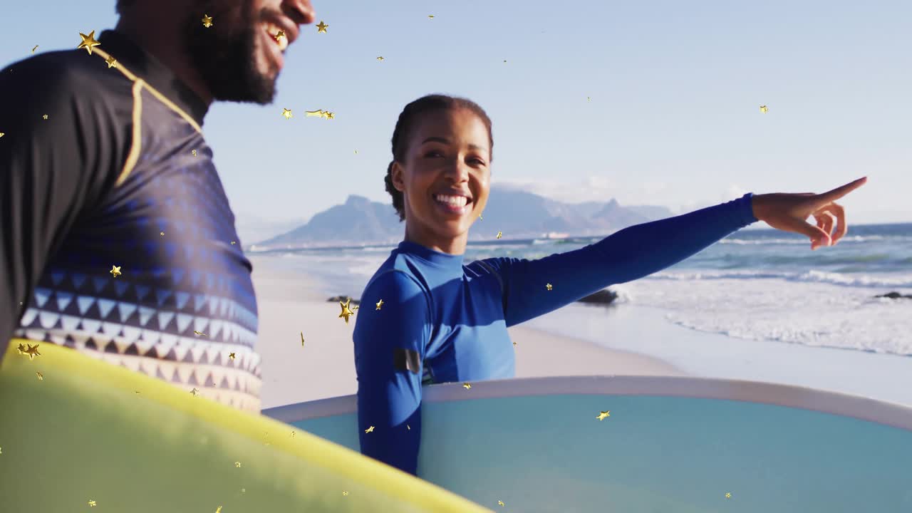 Sports couple scanning ocean, pointing toward cresting waves with star graphics showing excitement