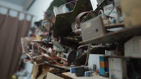 plenty of old and outdated PC components motherboard ram graphic sound card and cables stacked upon each other not useful anymore more electrical waste hurting environment recycling storing rubbish