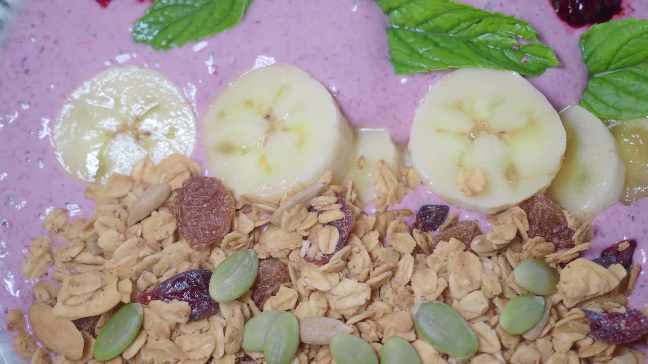 Smoothie bowl with banana, granola and mint