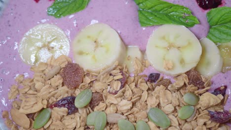 smoothie bowl with banana, granola and mint