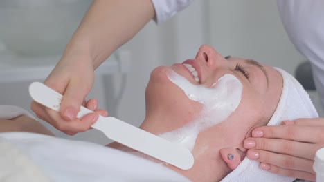 woman receiving facial beauty treatment