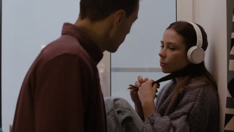 couple in conversation by the window