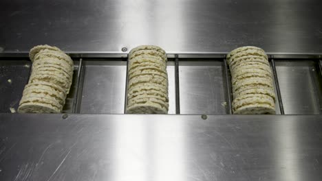 shot of a moving conveyor with einkorn cakes