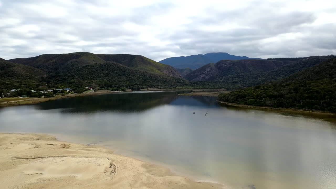 An aerial shot flying over the lagoon with reflections at Nature's Valley in the Garden Route of South Africa