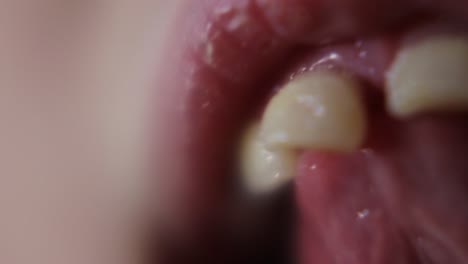 macro close up of young girl wiggling loose front teeth-1