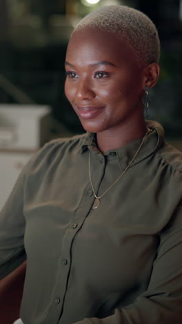 portrait of a smiling businesswoman sitting at her desk