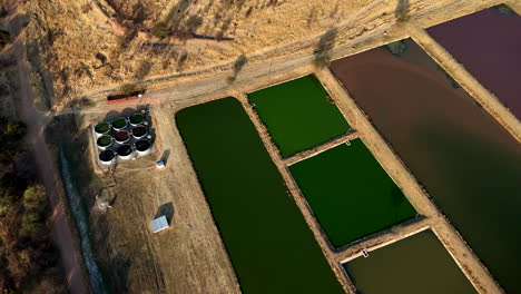 drone shot over a sewage treatment plant with its settling ponds at the different stages of the waste management process, africa