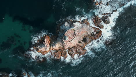 aerial view of rocky island with a structure