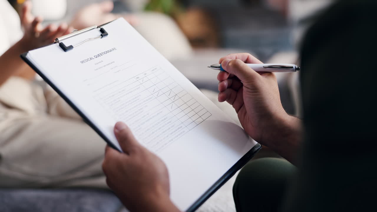 Close-Up of Hands Filling Out a Medical Questionnaire on a Clipboard