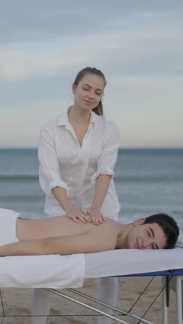 a man receives a massage on a beach