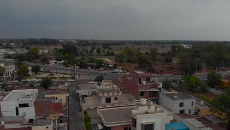 view of the traffic on the road on cloudy day from residential area of the populated city of punjab, india