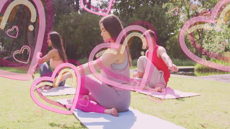 practicing yoga outdoors, women with pink heart animation overlay in nature