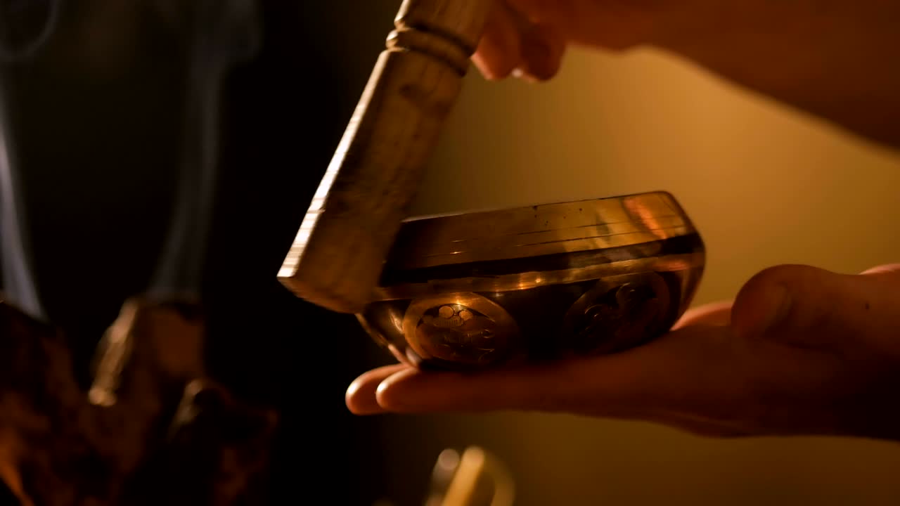 hombre tocando en el cuenco de canto tibetano