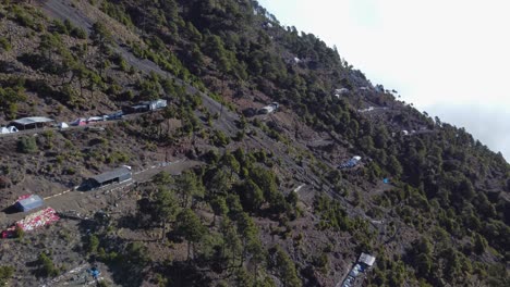 Basecamp-tents-ledges-in-steep-slope-of-volcanic-mountain,-Guatemala