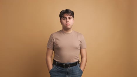 serious young man looking at camera standing hands on pocket