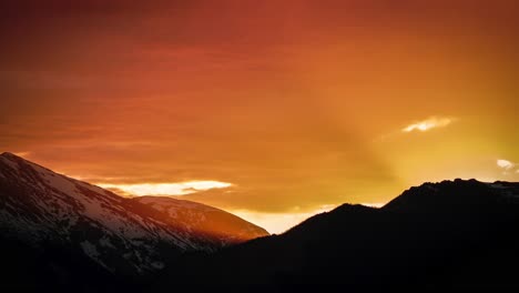 orange and yellow sunset time lapse of light breaking through rocky mountain's in estes park, colorado