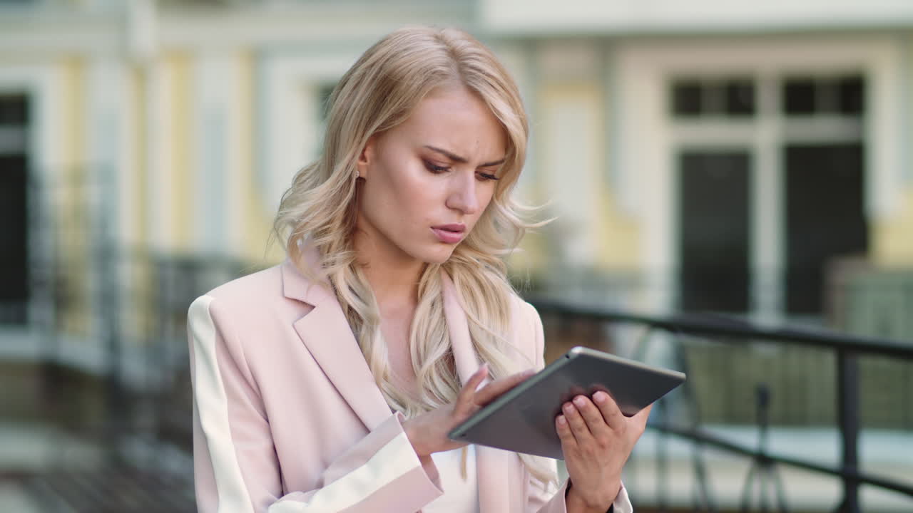 Closeup woman working with touchpad. Woman getting bad news on touchpad