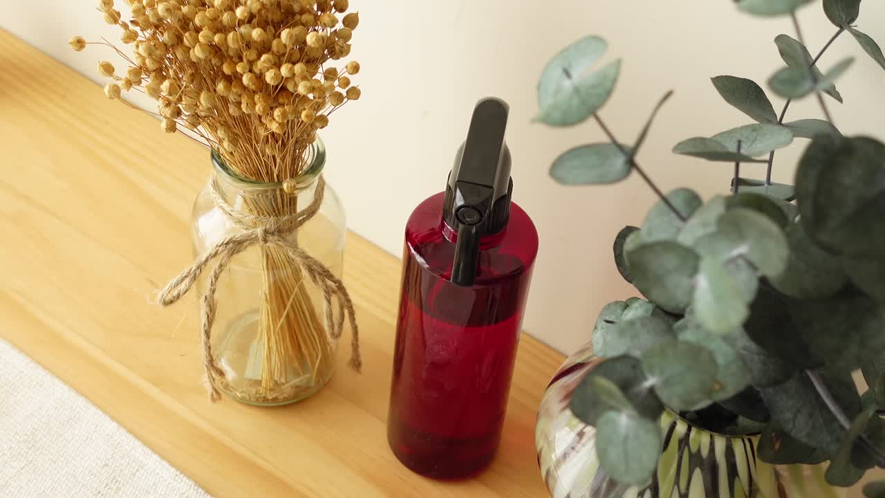 Still life of spray bottle and flower vases