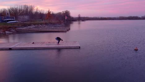 aerial-view-of-a-woman-doing-yoga-on-a-dock