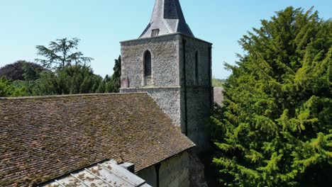 close up crane shot of a village church roof and tower from the quiet kent village of littlebourne in england