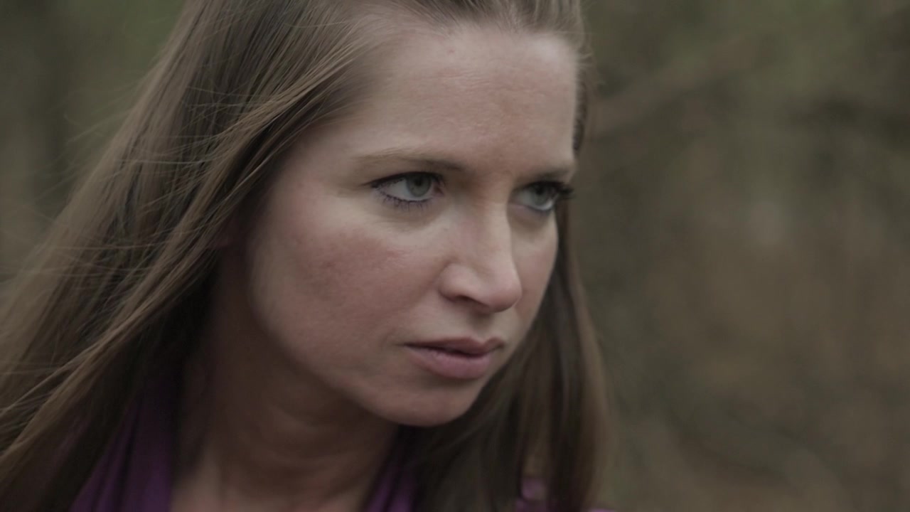 A lady archer looks up, readying her mind and spirit, for her shot. This clip is part of a series of twelve slow motion clips of her shooting.