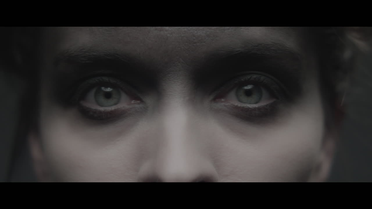 A woman dressed as mother opens her eyes