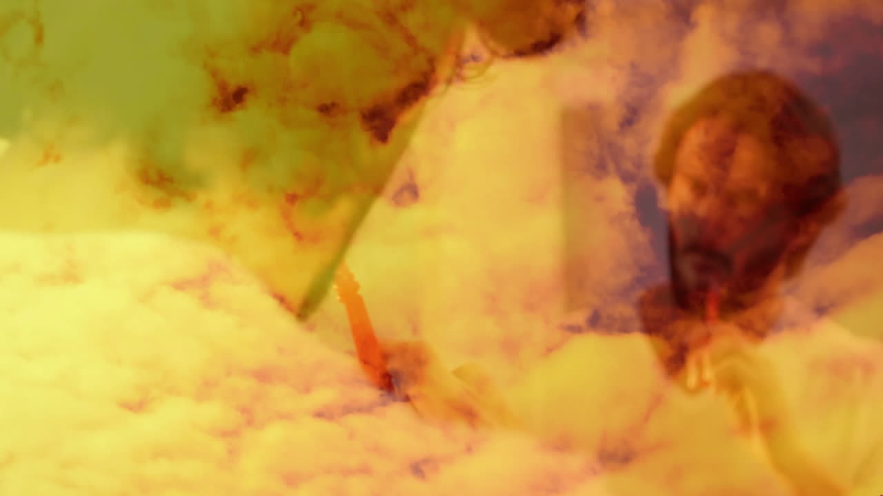 Animation of abstract figures blending with dreamy clouds in warm, golden hues