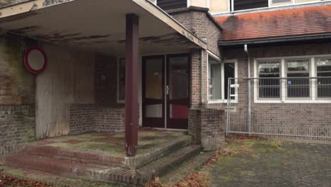 abandoned brick building with broken windows and doors