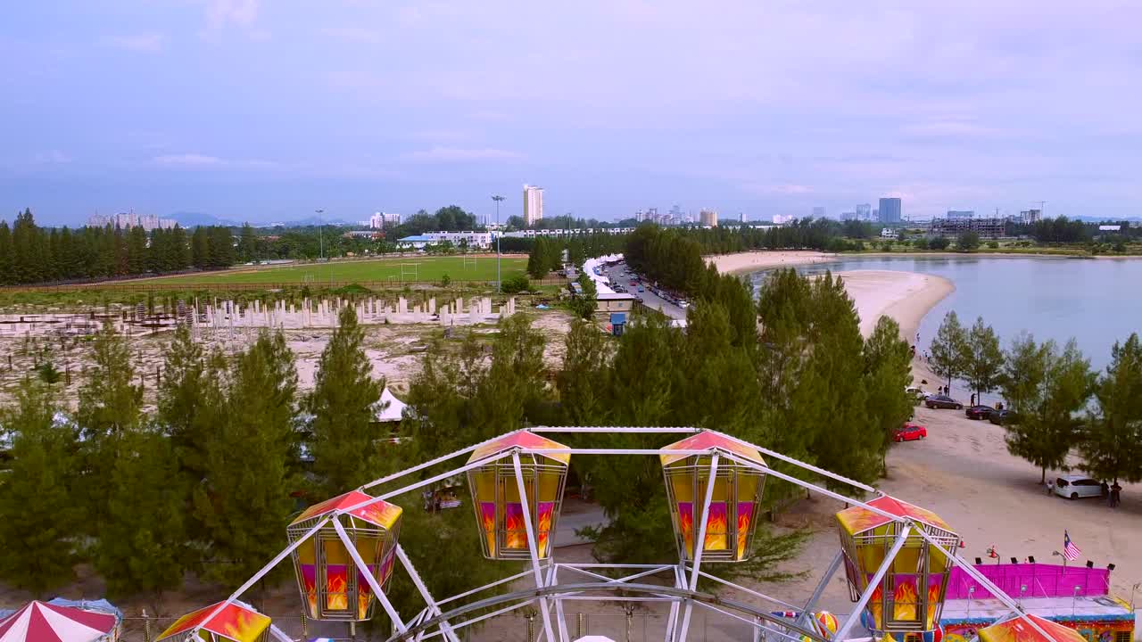 A Colorful Amusement Park Located At The Coast Of A Beautiful Ocean Captured On A Fine Sunny Day In Malaysia - Aerial Shot