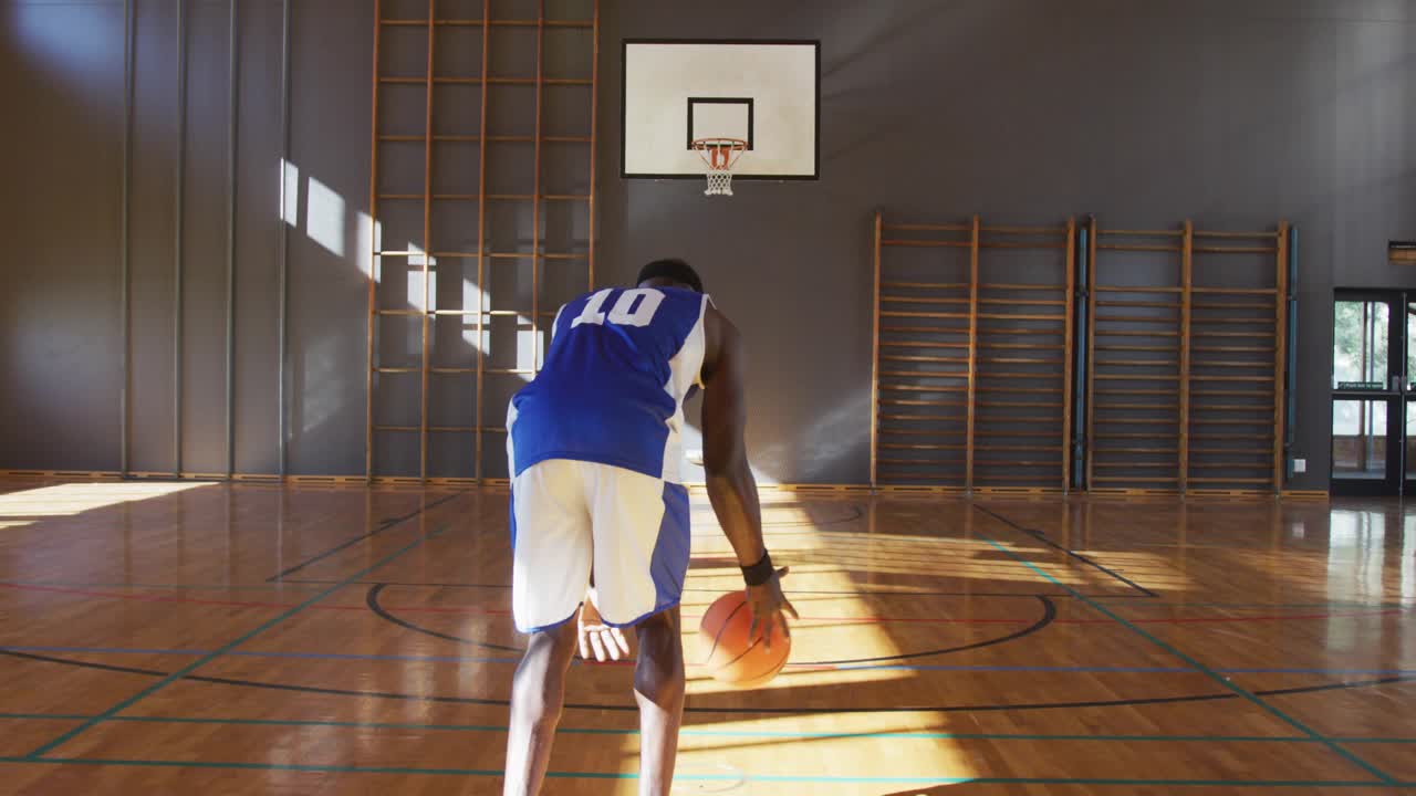 Male player starting dribble midcourt, animated path tracing ball for shot in sports training