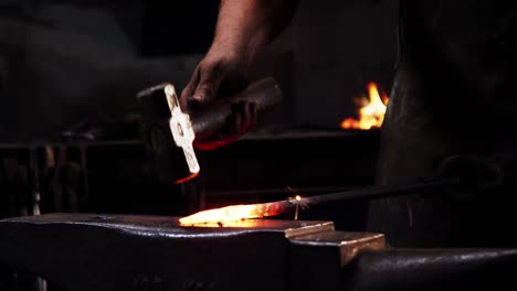 Mid-section-of-blacksmith-working-on-a-iron-rod