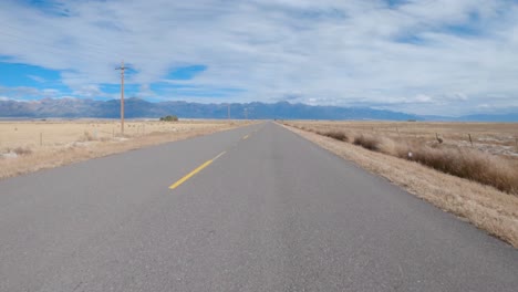 Driving-down-deserted-Colorado-highway-towards-the-Rocky-Mountains-during-fall