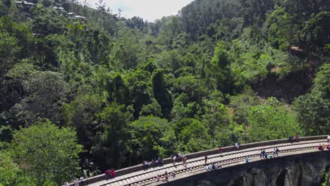 people exploring nine arches railway bridge, demodara, sri lanka, overtake low shot